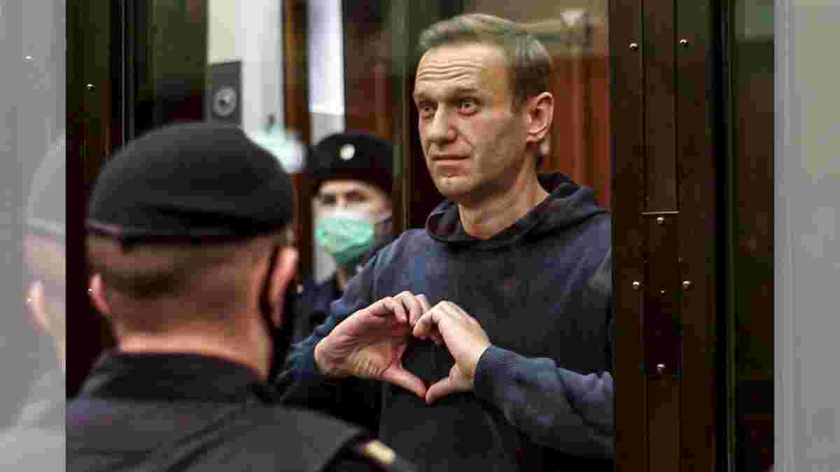Russian opposition leader Alexei Navalny shows a heart symbol while standing in a defendants’ cage during a hearing in the Moscow City Court in Moscow, Russia. Navalny, who died in an Arctic penal colony on Feb. 16, spent months in punishment cells for infractions like not buttoning his uniform properly or not putting his hands behind his back when required.