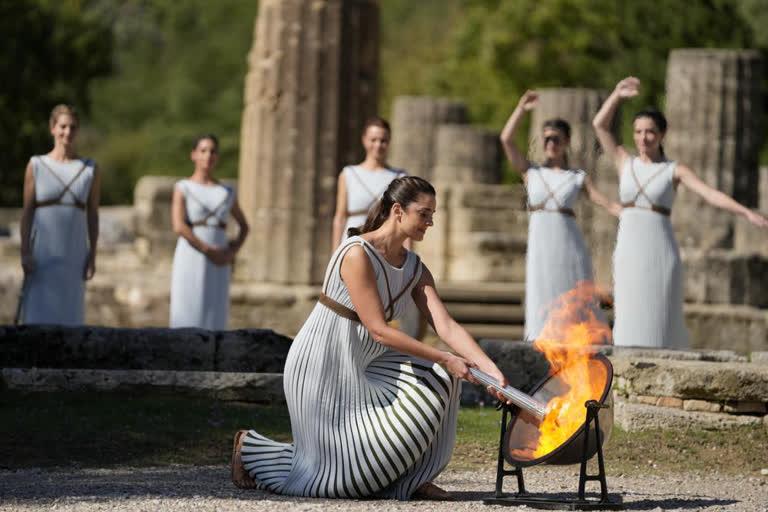 Greek Presidencial Guard soldiers march during the lighting of the Olympic flame at Ancient Olympia site, birthplace of the ancient Olympics in southwestern Greece, Monday, Oct. 18, 2021. The flame will be transported by torch relay to Beijing, China, which will host the Feb. 4-20, 2022 Winter Olympics.